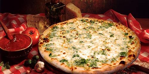 A pizza sitting on top of a table covered in cheese.